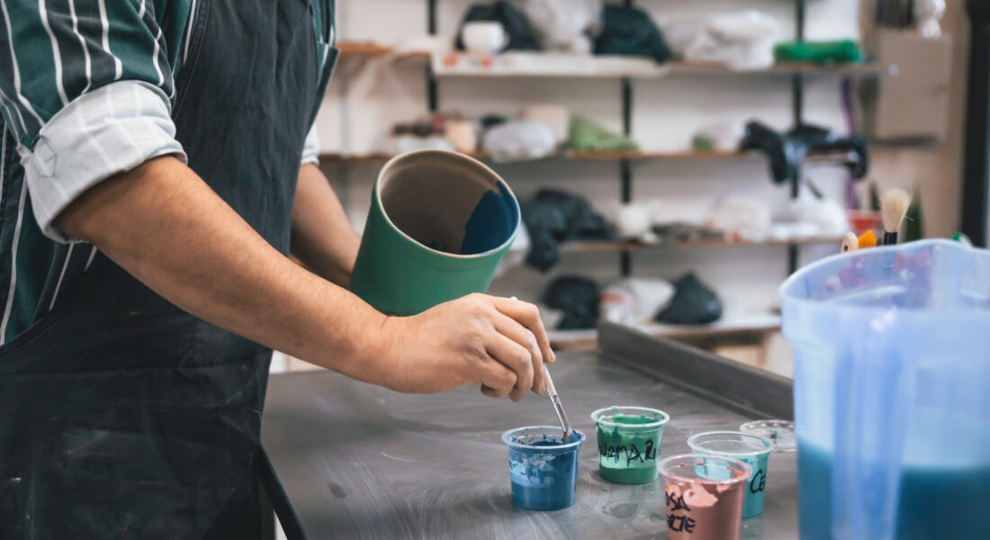 closeup-adult-person-painting-clay-pot-table-workshop closeup-adult-person-painting-clay-pot-table-workshop
